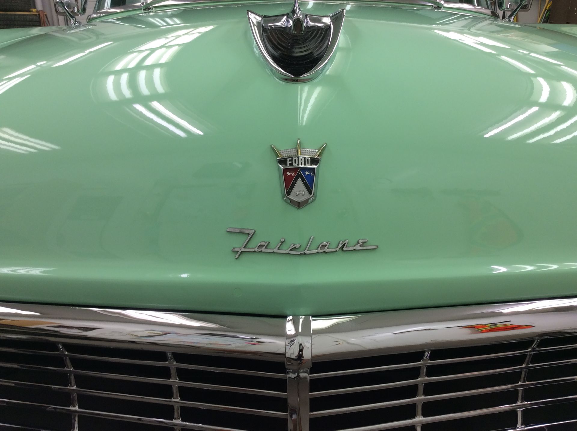 A close up of the hood of a green car