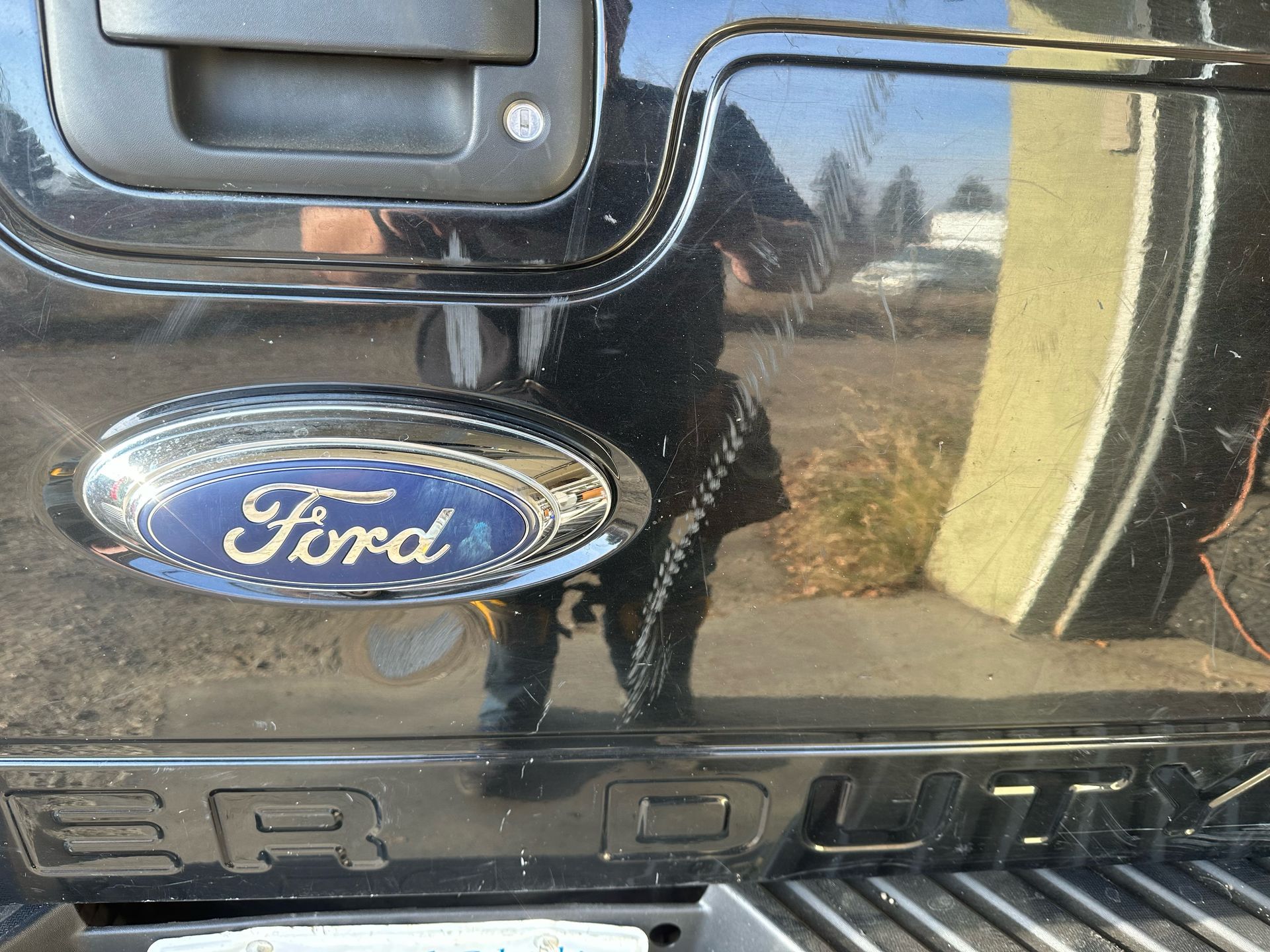 A close up of a ford logo on the back of a truck