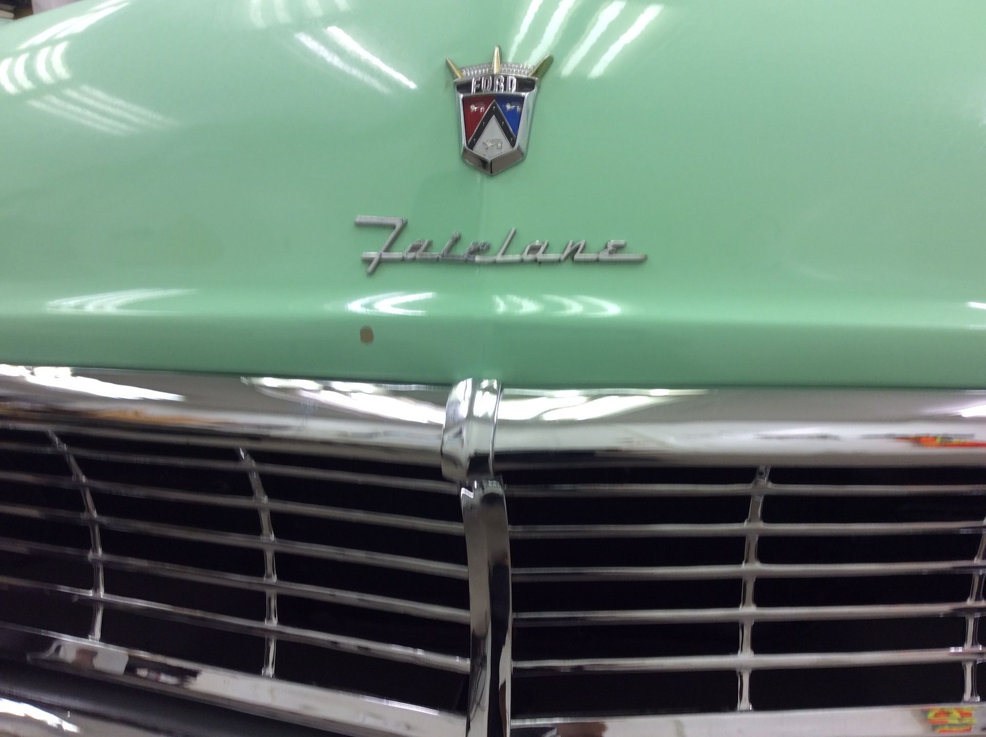 A close up of the front of a green ford falcon