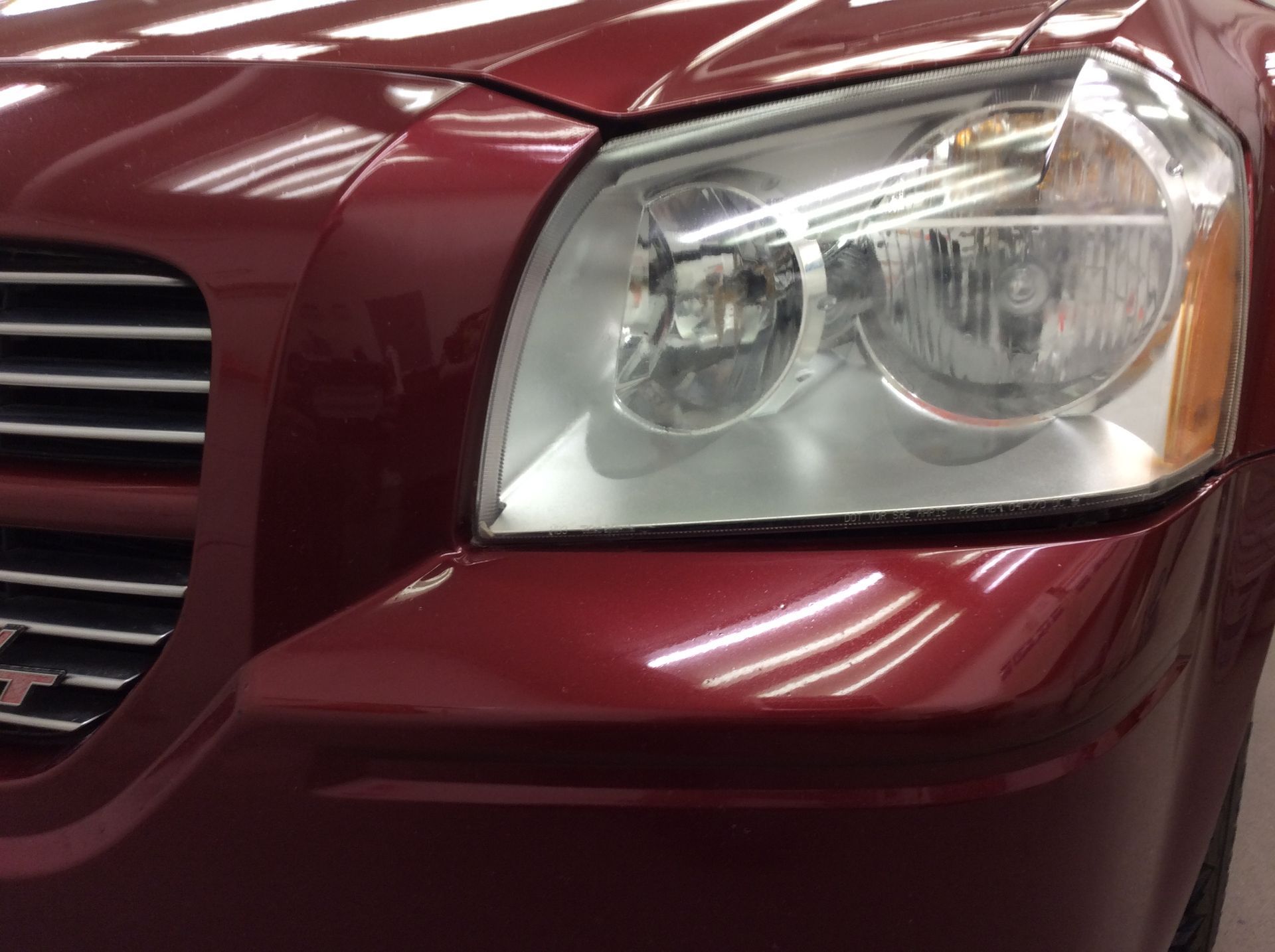 A close up of a red car 's headlight