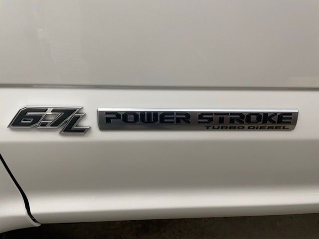 A white truck with a power stroke turbo diesel emblem on the side.