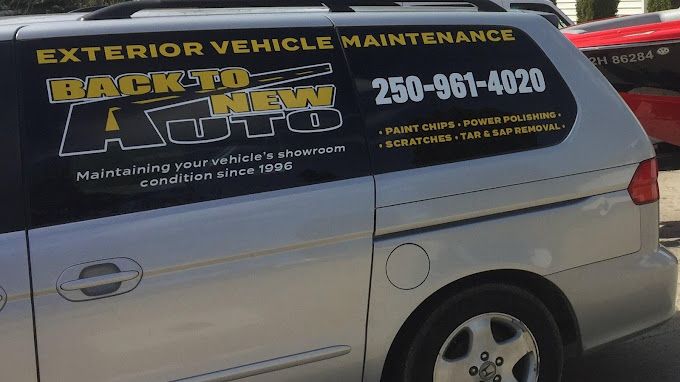 A back to new auto van is parked in a parking lot