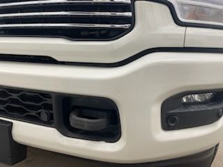 A close up of the front bumper of a white truck.