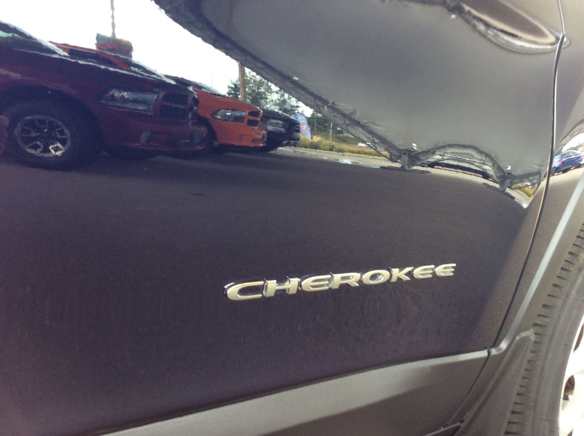 The word cherokee is on the side of a car