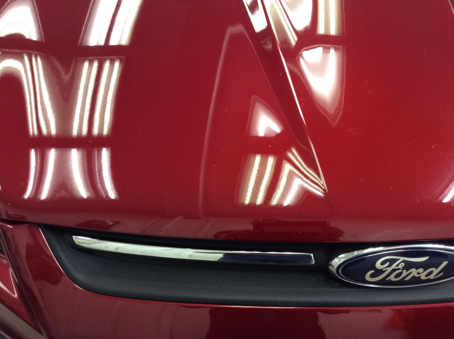 A close up of a red ford car