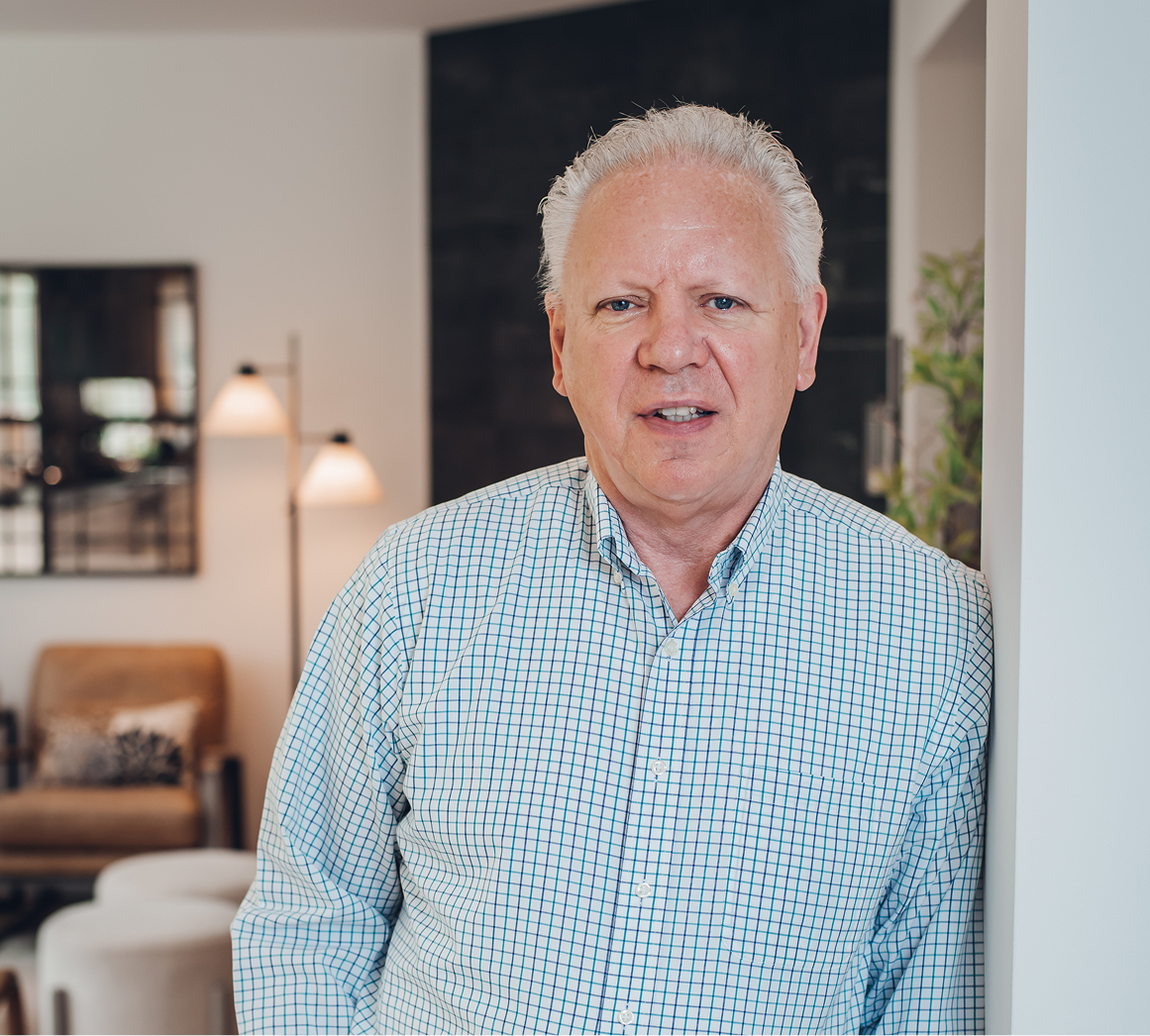 Bill Olson with a blurred living room in the background