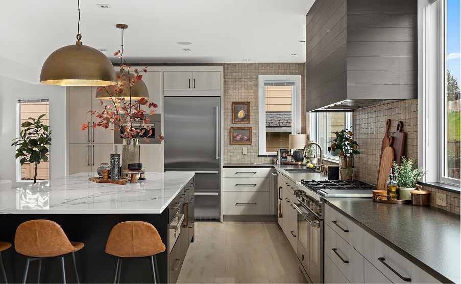 Modern kitchen with gray cabinets, marble island, wood stools, and pendant lights