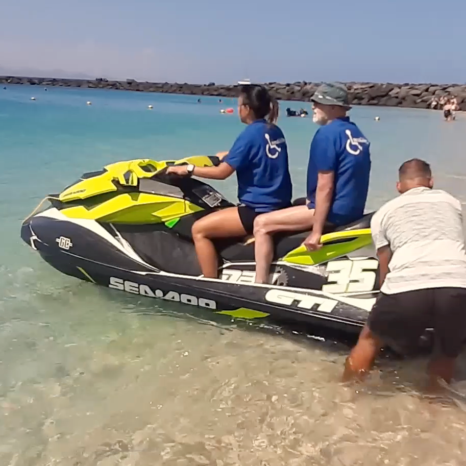 Two people on a jet ski with the number 35 on it