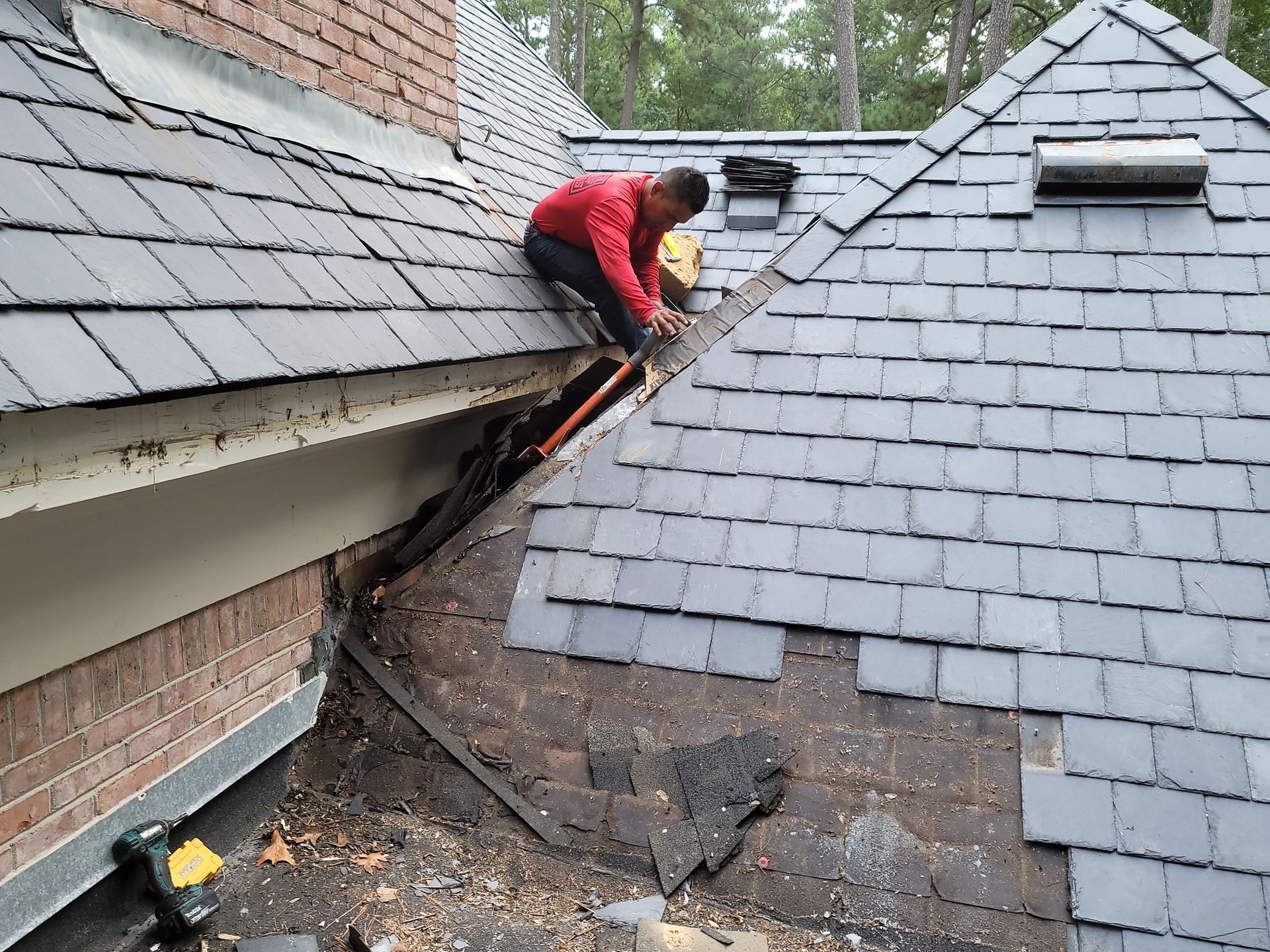 A brick walkway leading to a house with a wooden roof.