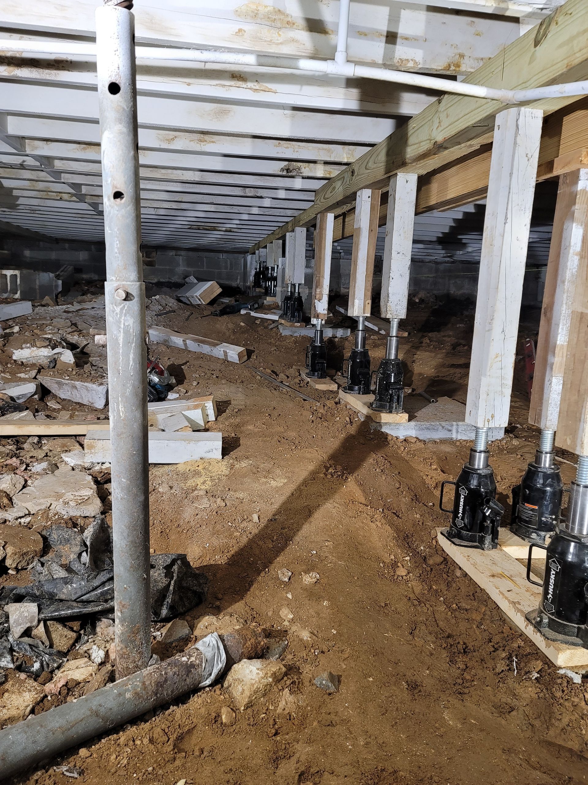 Two construction workers are standing next to each other at a construction site.