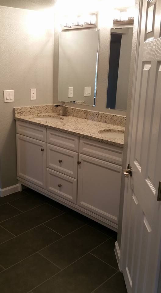 A sliding glass door with a white frame installed in a beige stucco wall, showing exposed edges around the frame.
