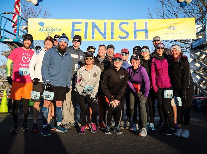 a group of people standing in front of a finish sign