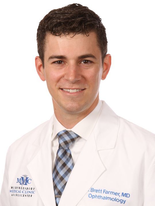 A man in a white coat and tie is named brett farmer md ophthalmology