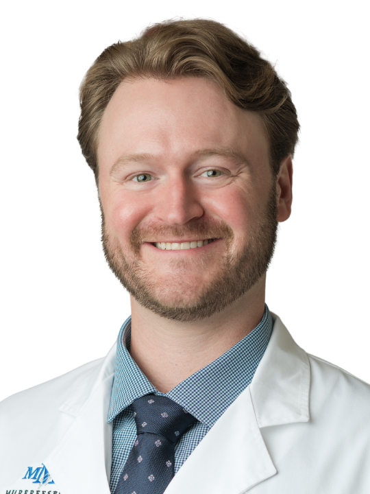 A man in a white coat and tie is named brett farmer md ophthalmology
