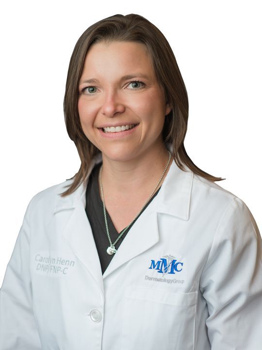 A woman wearing a white lab coat with the letters mmc on it