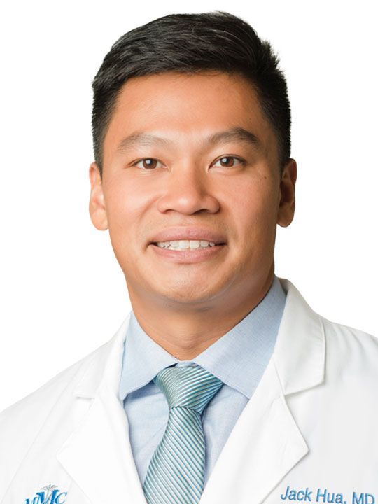 Jack hua md is wearing a white coat and tie