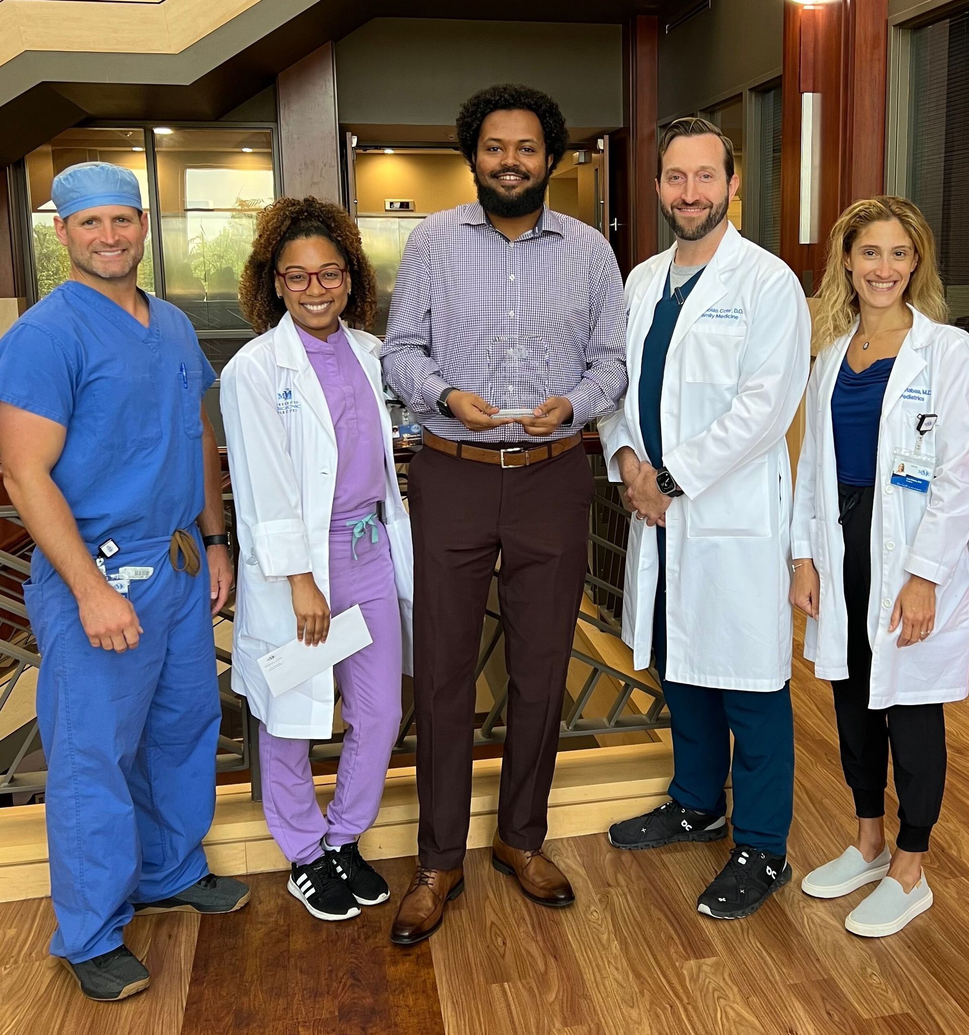 A group of doctors and nurses posing for a picture