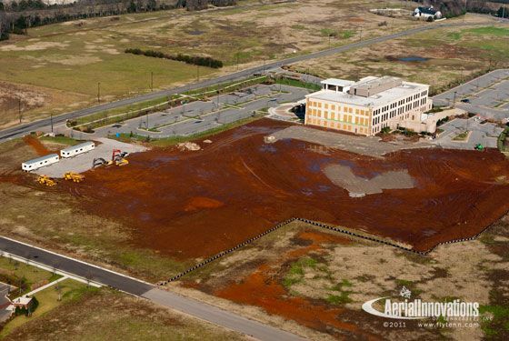 An aerial view of a building in the middle of a field.