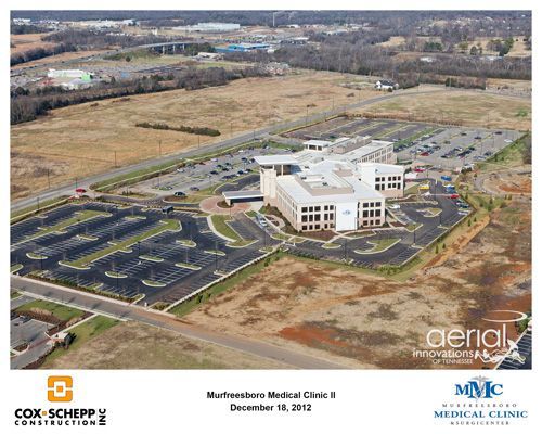 An aerial view of a large building with a lot of parking spaces