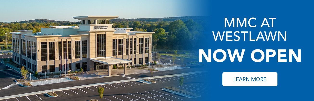 An aerial view of a large building with the words mmc at westlawn now open.