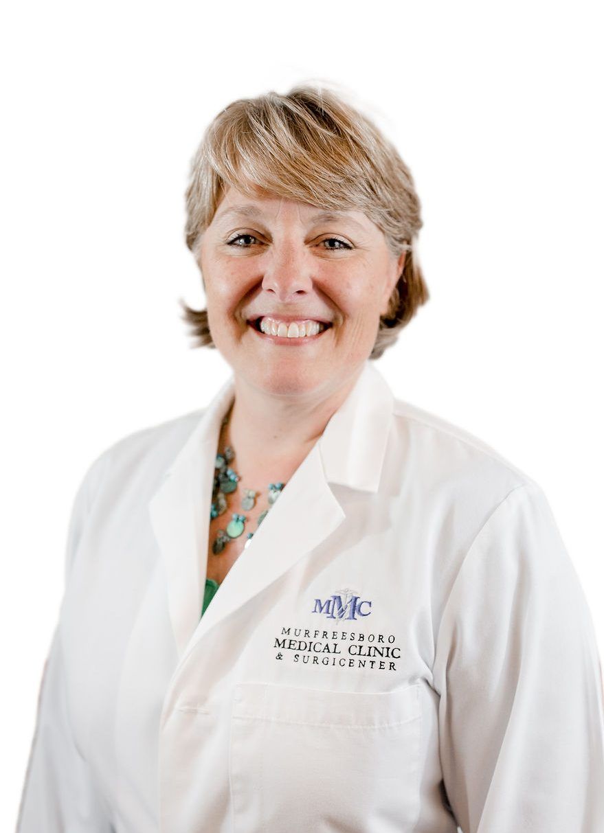 a woman wearing a white lab coat that says mmc on it