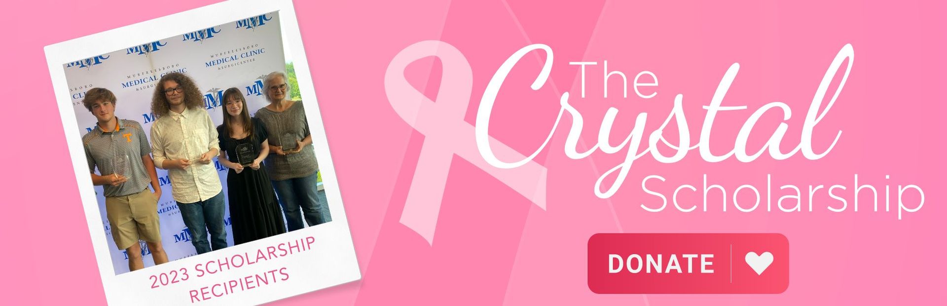A group of people are standing next to each other in front of a pink ribbon.
