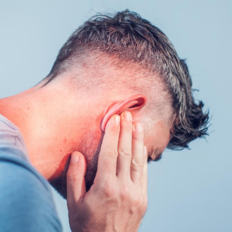 A man is covering his ears with his hands.