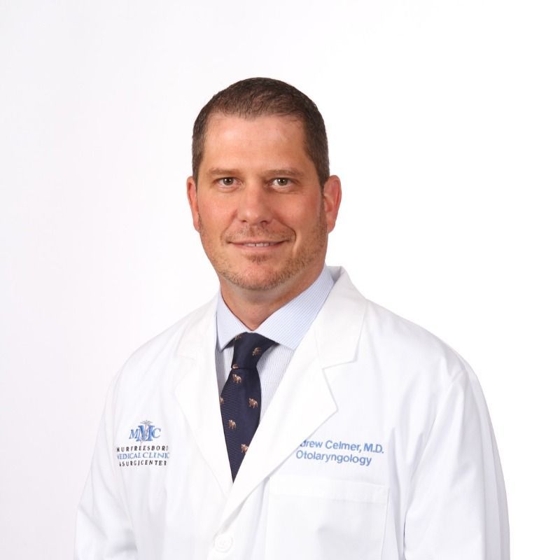 A man in a white coat and tie is a doctor