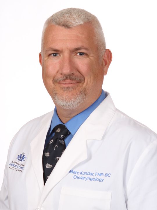 A man in a white coat and blue tie is a doctor