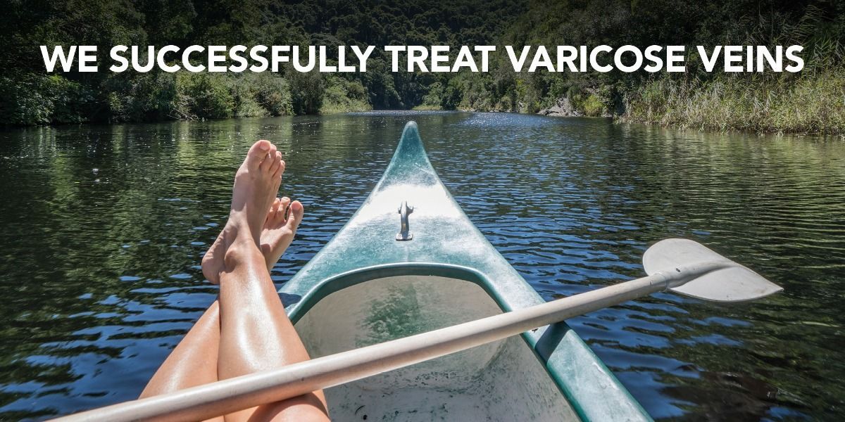 A person is sitting in a kayak on a river with their legs crossed.
