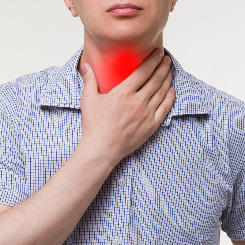 A man is holding his throat because he has a sore throat.