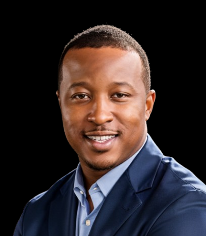 A person with a short haircut, wearing a blue blazer and light blue shirt, smiles against a plain black background.