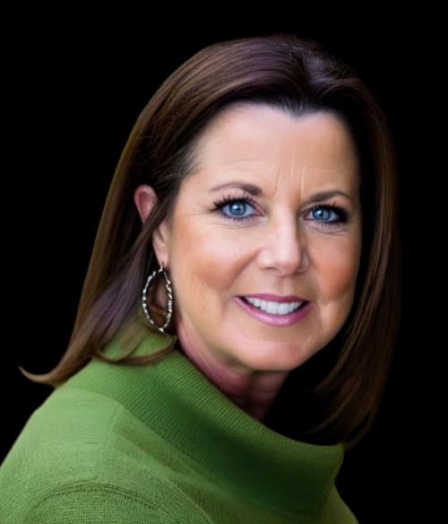 Smiling professional with shoulder-length brown hair, wearing a green turtleneck, against a solid black background.