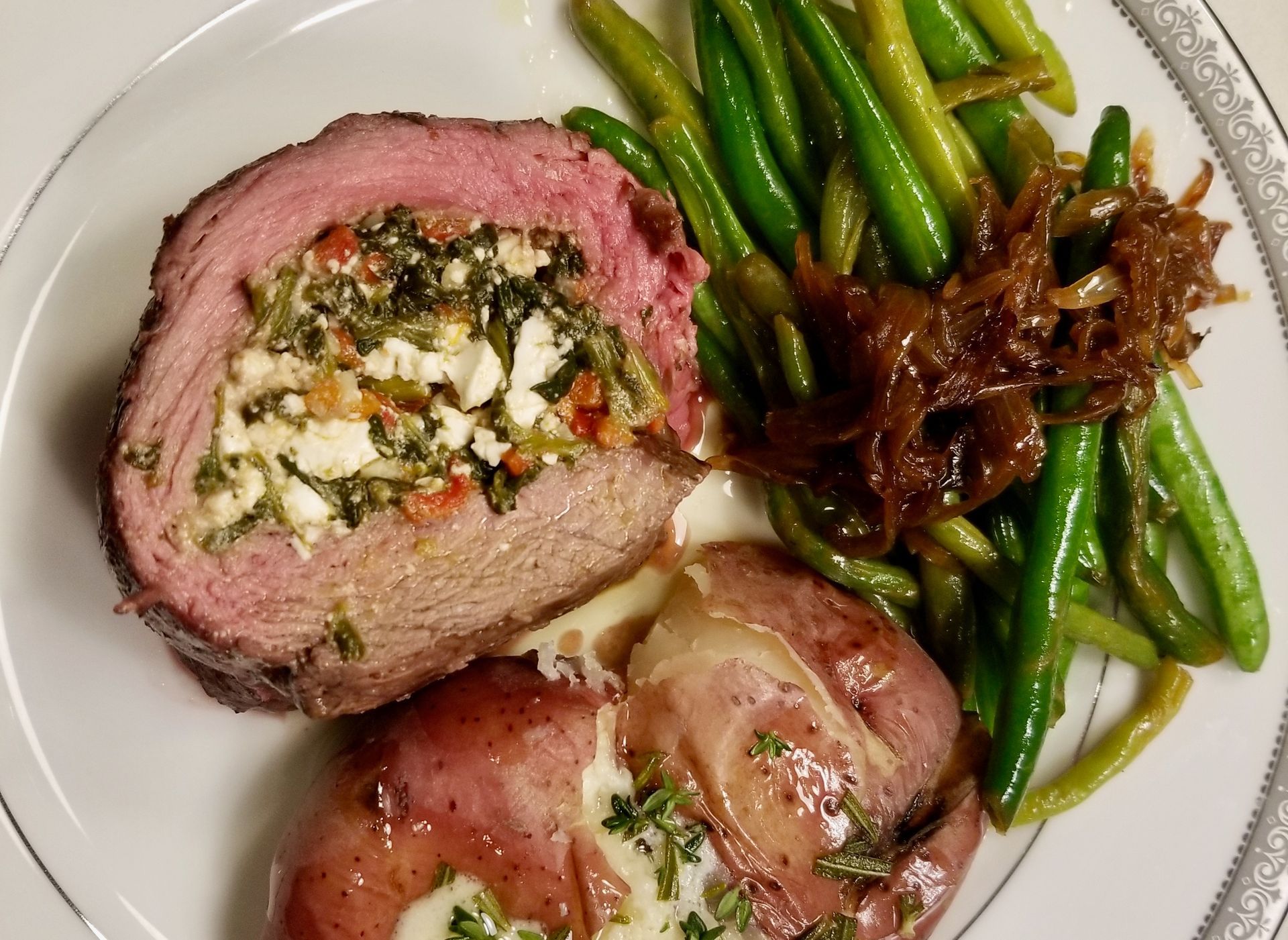 A white plate topped with meat and green beans