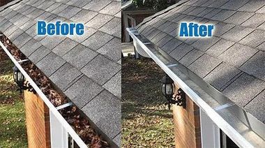 Gloved hand clearing wet leaves from a red shingled roof near a dormer window