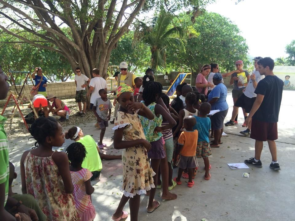 A group of people are gathered under a tree