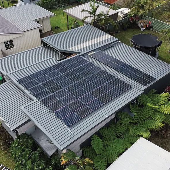 An Aerial View of a Flat Roof With Solar Panels on it — DLG Electrical and Solar In Wyong, NSW