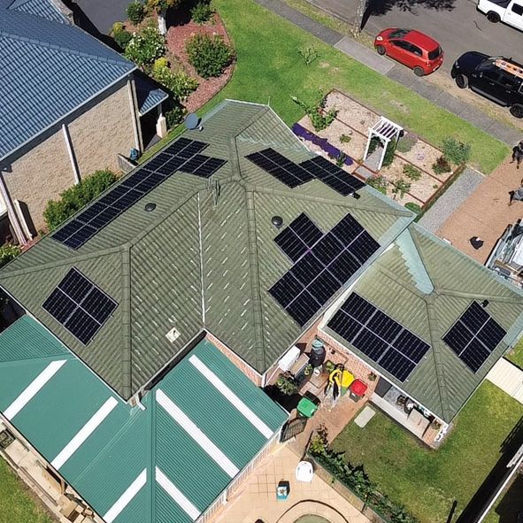 An Aerial View of a Green Roof With Solar Panels on it — DLG Electrical and Solar In Wyong, NSW