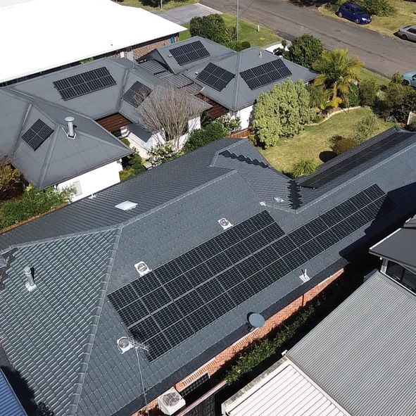 An Aerial View of a House Roof With Solar Panels on it — DLG Electrical and Solar In Wyong, NSW