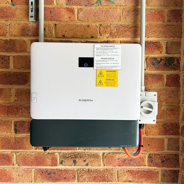 A Solar Panel is Mounted on a Brick Wall — DLG Electrical and Solar In Wyong, NSW