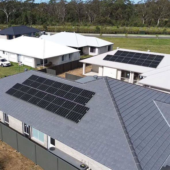 An Aerial View of a House With Solar Panels on the Roof — DLG Electrical and Solar In Wyong, NSW