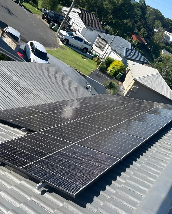 A Row of Solar Panels on the Roof of a House — DLG Electrical and Solar In Wyong, NSW