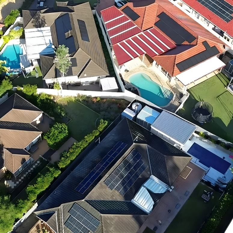 An Aerial View of a Residential Area With Solar Panels on the Roofs — DLG Electrical and Solar In Newcastle, NSW
