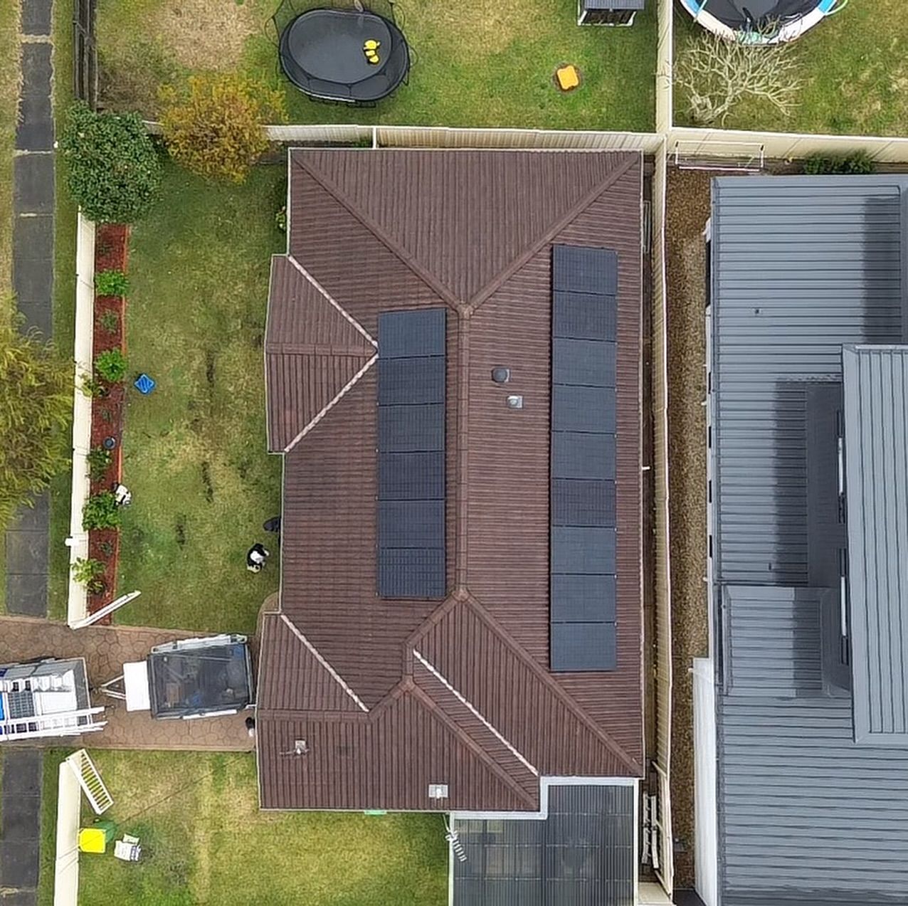 A House With Solar Panels on the Roof — DLG Electrical and Solar In Wyong, NSW