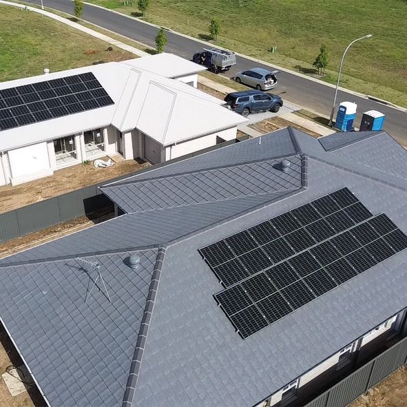 An Aerial View of a House With Solar Panels on the Roof — DLG Electrical and Solar In Wyong, NSW