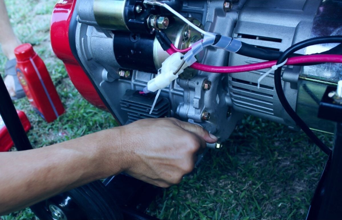 A Person is Working on a Generator With a Pair of Pliers — DLG Electrical and Solar In Hunter Valley, NSW