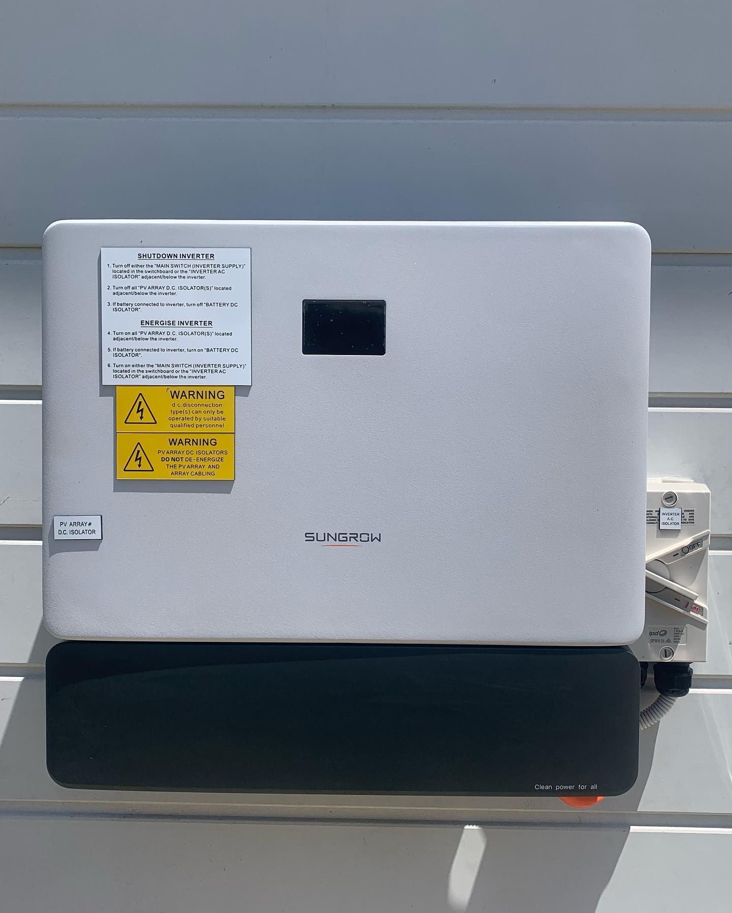 A White Box With a Yellow Warning Label on It — DLG Electrical and Solar In Port Stephens, NSW