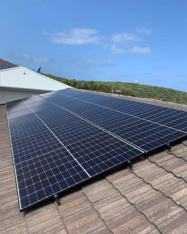 There Are Many Solar Panels on the Roof of a House — DLG Electrical and Solar In Port Stephens, NSW