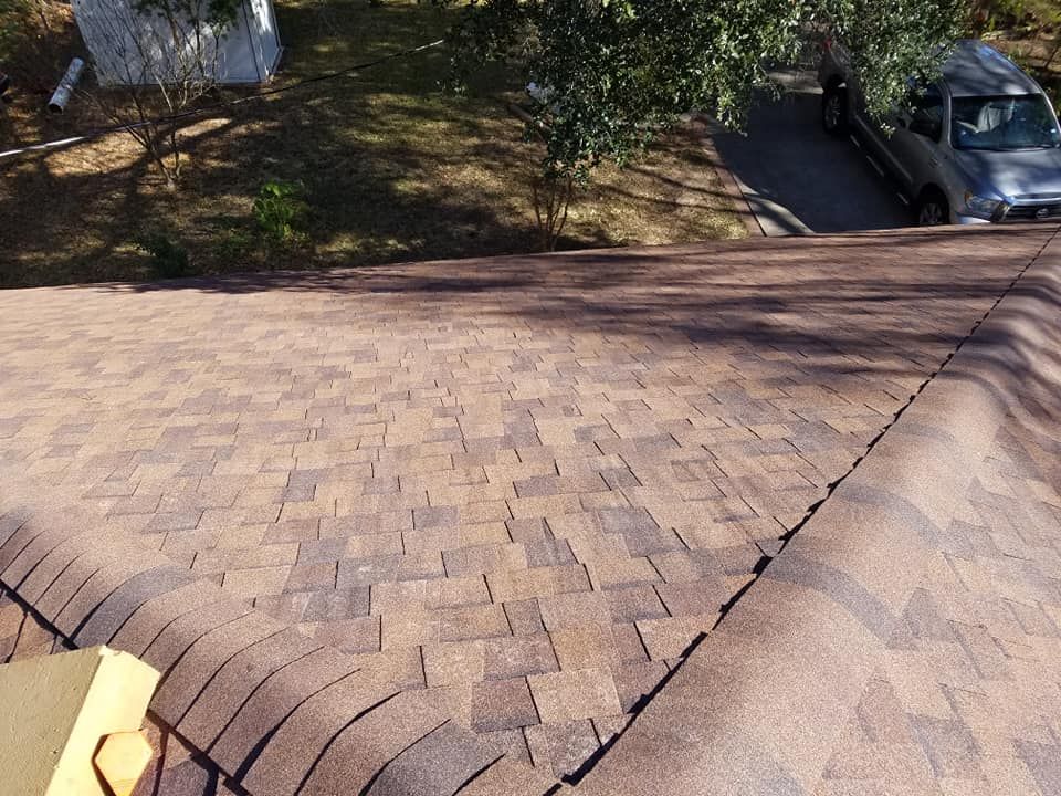 A car is parked on the roof of a house.