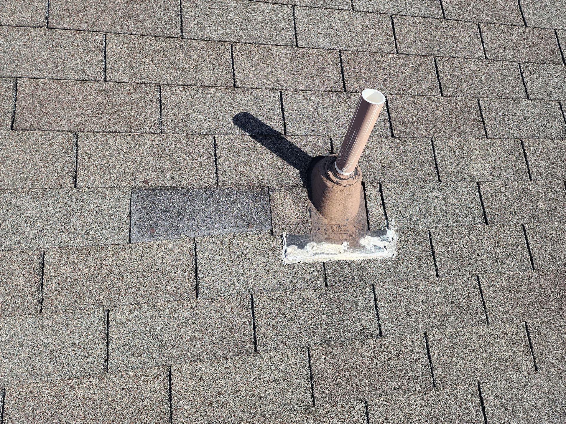 A pipe is sitting on top of a roof.